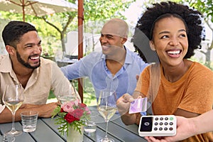 Woman Making Contactless Payment At Outdoor Bar Or Restaurant Using Credit Or Debit Card