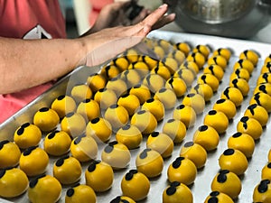 The woman is making cookies stuffed with pineapple.