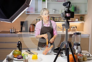 Woman making cooking vlog, recording herself on camera