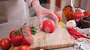 Woman making cuts for tomato blanching