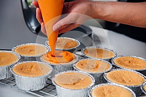 Woman during making decorating cooking bakery cake