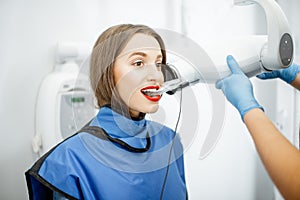 Woman making dental x-ray shot