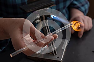 Woman  making glass bead