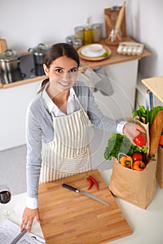 Woman making healthy food standing smiling in