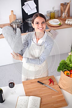 Woman making healthy food standing smiling in kitchen