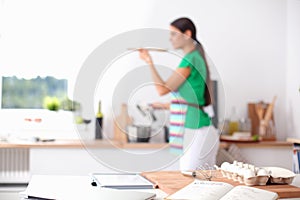 Woman making healthy food standing smiling in kitchen