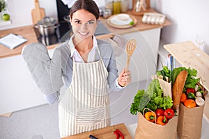 Woman making healthy food standing smiling in kitchen