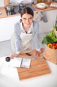 Woman making healthy food standing smiling in kitchen