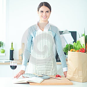 Woman making healthy food standing smiling in kitchen