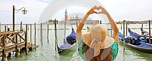 Woman making heart shape with hands on beautiful view of Venice