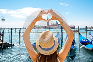 Woman making heart shape in Venice