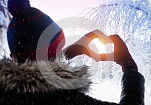 Woman making heart symbol with hands