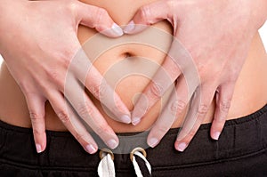 Woman Making a Heart Symbol over her Tummy