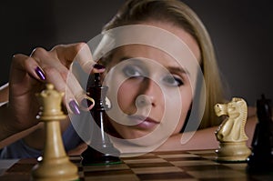 Woman making her move in chess