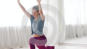 Woman making high lunge exercise at yoga studio