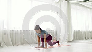 Woman making high lunge exercise at yoga studio