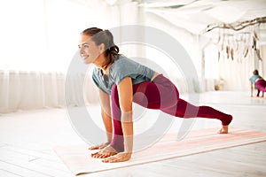 Woman making high lunge exercise at yoga studio