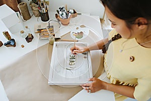 woman making home decor, top view of table