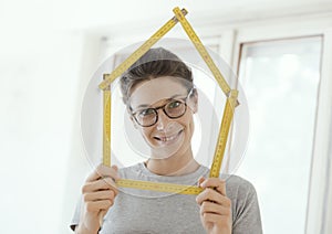 Woman making a house shape with a folding ruler