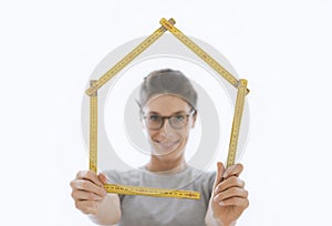 Woman making a house shape with a folding ruler