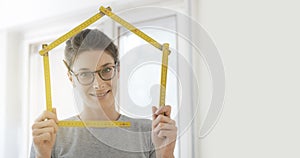 Woman making a house shape with a folding ruler