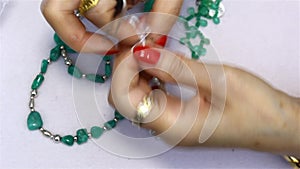 A woman making jewelry with Colombian emeralds