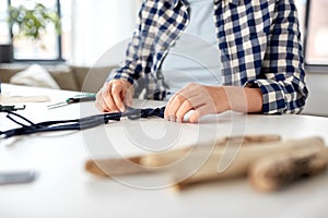 woman making macrame and knotting cords