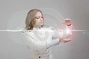 Woman making magic effect - flash lightning. The concept of electricity, high energy.