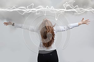 Woman making magic effect - flash lightning. The concept of electricity, high energy.