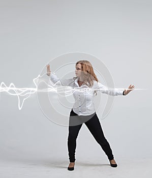 Woman making magic effect - flash lightning. The concept of electricity, high energy.