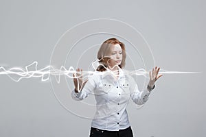 Woman making magic effect - flash lightning. The concept of electricity, high energy.