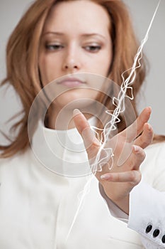 Woman making magic effect - flash lightning. The concept of electricity, high energy.