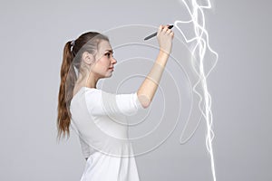 Woman making magic effect - flash lightning. The concept of electricity, high energy.