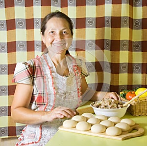 Woman making meat dumplings