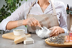 Woman making natural handmade soap at stone table, closeup