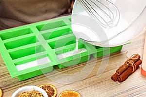 Woman making natural handmade soap at table, closeup