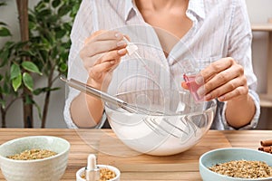 Woman making natural handmade soap at table, closeup