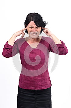 Woman making noise hurting her ears on white background
