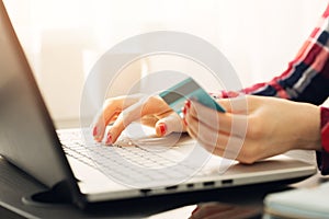 Woman making online payment with credit card