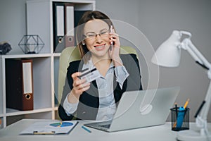 Woman making online purchase. Online payment service. Close up of woman hands hold credit card and using laptop for