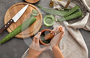 Woman making organic cosmetics with aloe. Health care concept