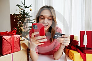 Woman making payment online before Christmas celebration