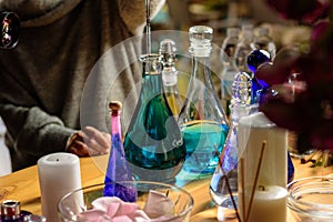 Woman making perfume with test tubes in craft workshop