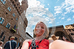 Woman making a photo near Palazzo Vecchio, in Florence.
