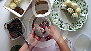 A woman is making a potato `Potato`. He rolls a cake and rolls it in cocoa.