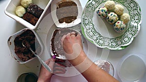 A woman is making a potato `Potato`. He rolls a cake and rolls it in cocoa.