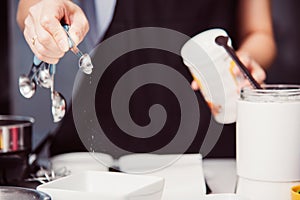 Woman during making pour measure dough