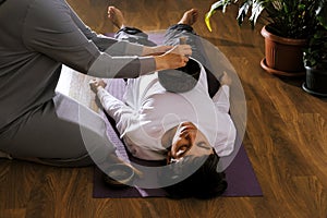 Woman making relaxing massage for young man.  Meditation, sound therapy with Tibetan singing bowls