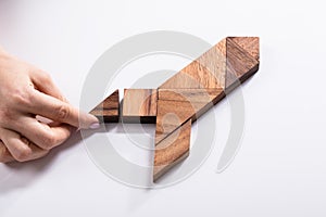 Woman Making Rocket With Wooden Tangram Puzzle