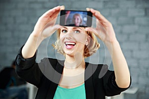 Woman making a self photo by her smartphone